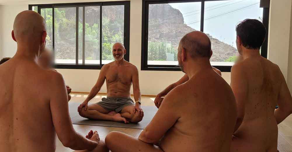 Men sitting together in a clothing-optional retreat circle in the Casa Agama studio