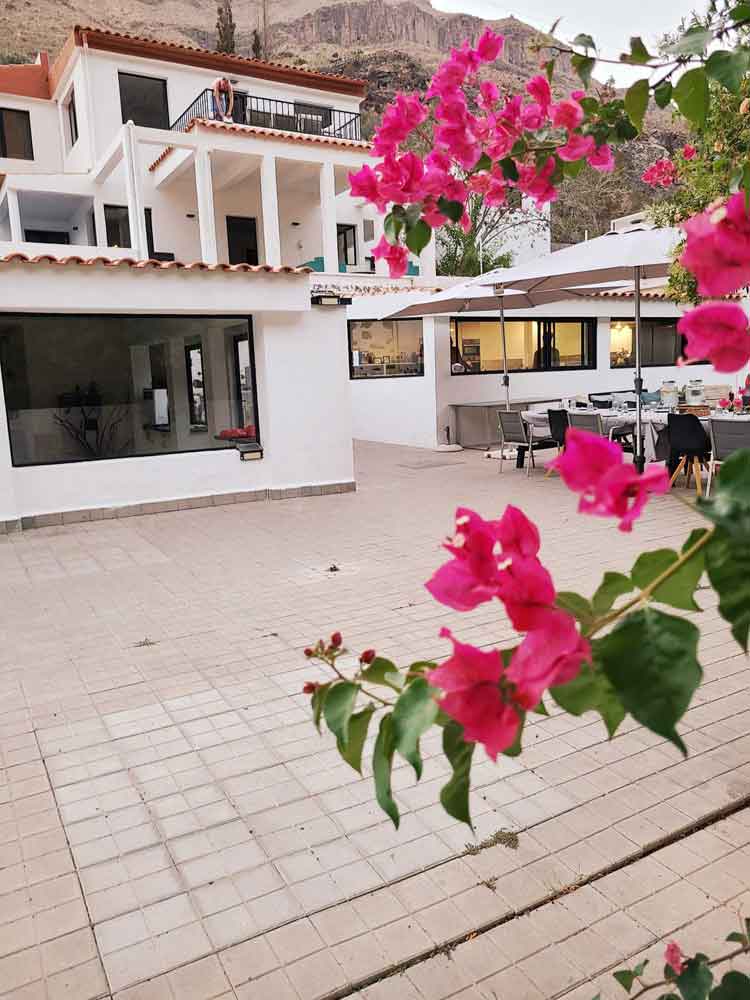 Casa Agama courtyard framed by vivid bougainvillea and mountain rock
