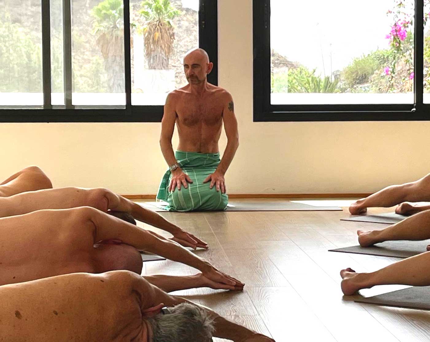 Jamie guiding a quiet clothing-optional movement session in the studio